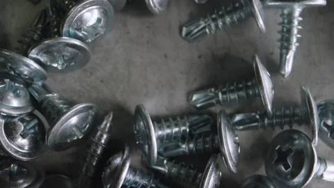 Close Up Metal Screws Scattered Workshop Or Surface For Commercial Use Video stock 333209444