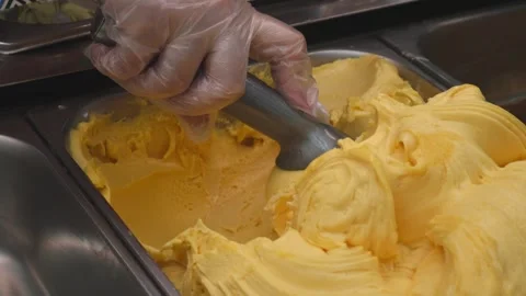 Close-up of a metal spoon slowly scooping creamy frozen ice cream Stock Footage 309136509