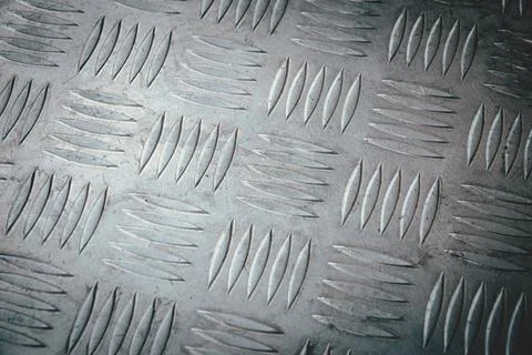 A close up of a metal surface with a pattern of squares and triangles 写真素材