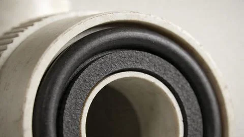 Close-up of metal threaded pipe connector with rubber sealing ring. Detail of pl Stock Photos