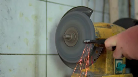 Close-up of a metal workpiece being processed on a grinding machine Stock Footage 310028361