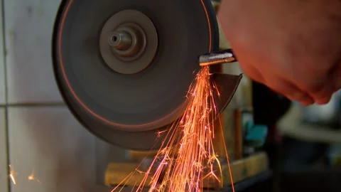 Close-up of a metal workpiece being processed on a grinding machine Stock Footage 310028407