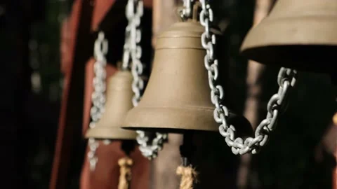 Close up metallic bells hanging in a row outdoors. Stock Footage 217878315