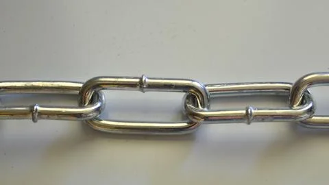 Close up of a metallic chain with interlocking links Stock Photos