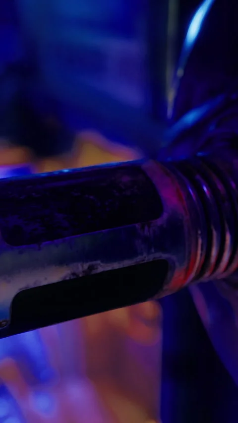 Close up of a metallic component with glowing lights in a vibrant setting Stock Footage 327781029