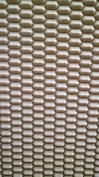 Close-up of metallic hexagon pattern on textured surface Stock Photos
