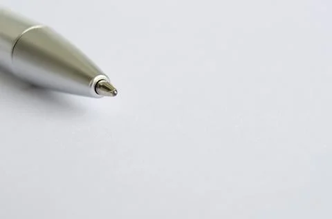 Close-up of metallic pen on white notepad with customizable space for text .. Stock Photos