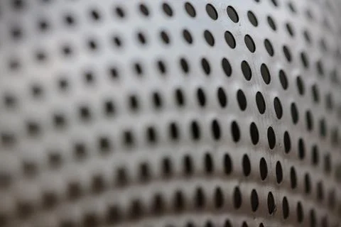 Close-up on a metallic perforated surface or metal grate with uniformly sized Stock Photos
