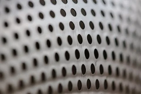 Close-up on a metallic perforated surface or metal grate with uniformly sized 스톡 사진