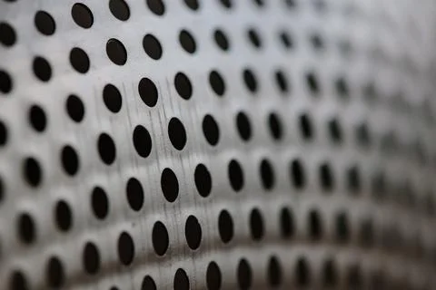 Close-up on a metallic perforated surface or metal grate with uniformly sized 스톡 사진
