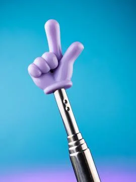Close-up of a metallic pointer in the shape of a hand with the index finger o Stock Photos