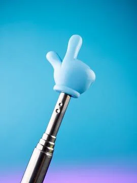 Close-up of a metallic pointer in the shape of a hand with the index finger o Stock Photos