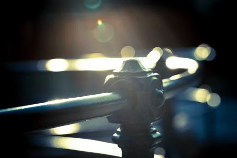 Close-Up of a Metallic Railing with Sunlight Reflections Stock Photos