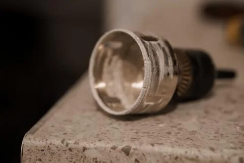 Close-Up of a Metallic Socket Wrench on a Textured Countertop Stock Photos