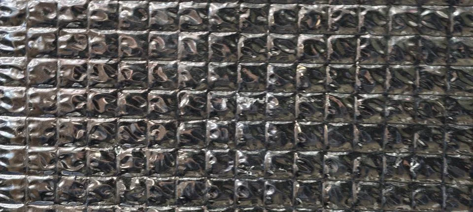 Close‑up of a metallic surface composed of small square segments Fotos Stock