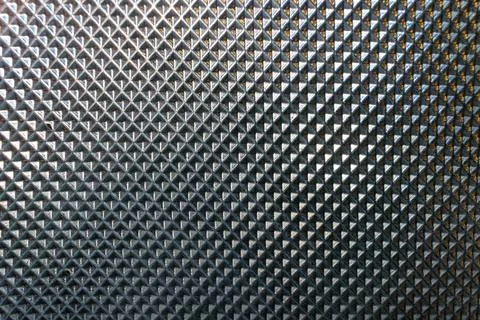 Close-up of metallic surface with diamond-shaped pattern 库存照片