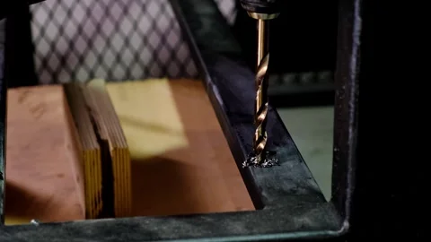 Close-up metallic twisting drill bit drilling a dark metallic surface, stained Stock Footage 338402370
