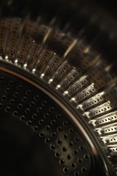 Close-Up of Metallic Washing Machine Drum with Abstract Lighting and Patterns Stock Photos