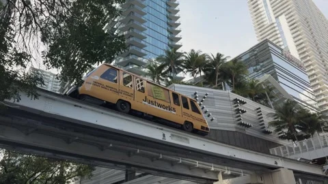 Close-Up of Miami Metromover on Elevated Track in Downtown at Sunset 動画素材 317828494