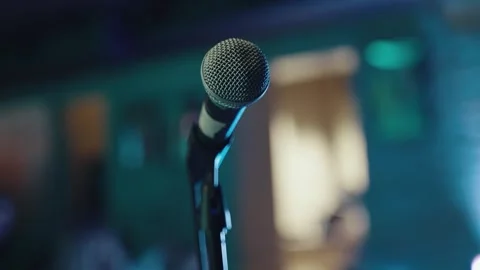 Close up of a mic on scene with rainbow lights and bokey Stock Footage 258168909