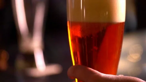 Close-up of micro brew amber-colored beer in glass. Stock Footage 100650269