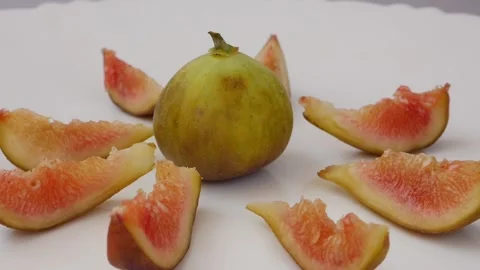 Close micro shot of fig fruit in center and slices around Stock Footage 148211449