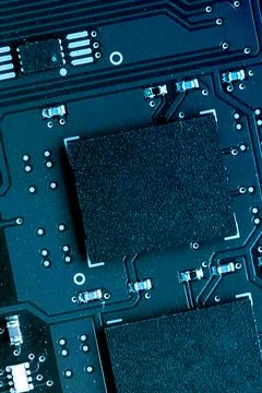 Close Up of Microchip on Electronic Circuit Board in Blue Tones Stock Photos