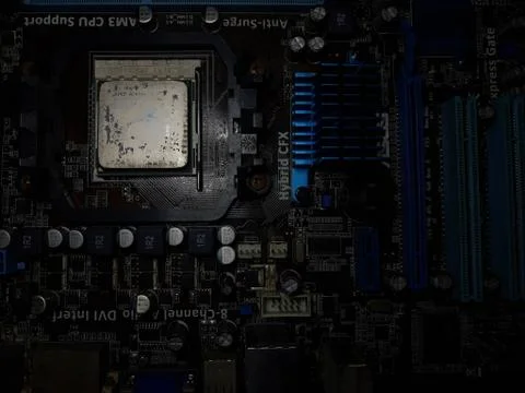 A close-up microchip with many electrical components placed on the Motherboard Stock Photos