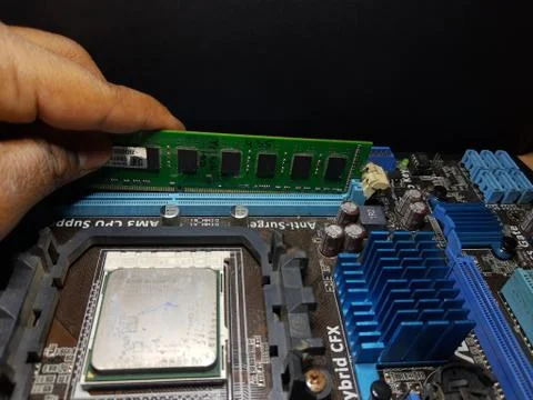 A close-up microchip with many electrical components placed on the Motherboard Foto stock