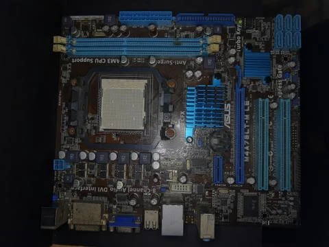 A close-up microchip with many electrical components placed on the Motherboard Stock Photos