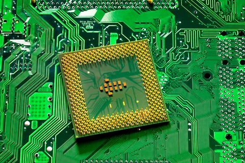 Close up of microchips and pins on Main CPU PC processor circuit board.. Stockfoto's