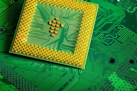 Close up of microchips and pins on Main CPU PC processor circuit board. Ma... Stock Photos