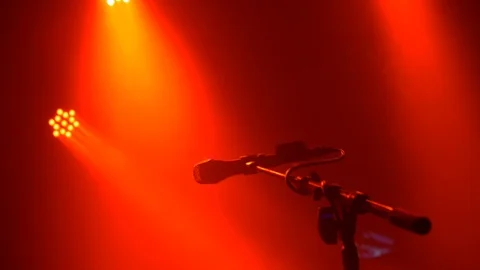 Close-up of microphone and mic stand under red lights live at concert. Video stock 109144623
