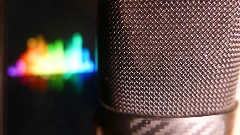 Close-up: microphone in an audio recording studio. Colorful sound levels moving Stock Footage 347424978