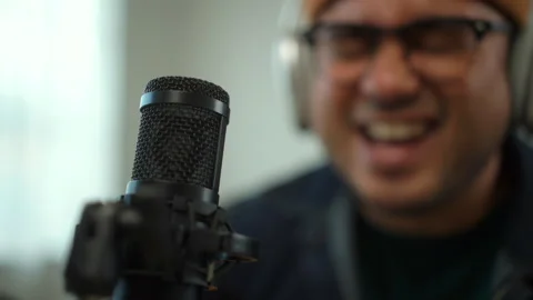 Close up of microphone with blur background of happy young musician man enjoy pl Stock Footage 282793905