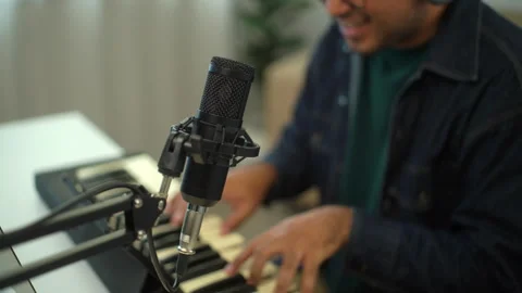 Close up of microphone with blur background of happy young musician man enjoy pl Stock Footage 282794889