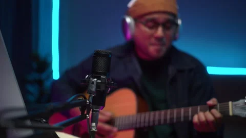 Close up of microphone with blur background happy musician man playing guitar. Stock-Footage 282795796