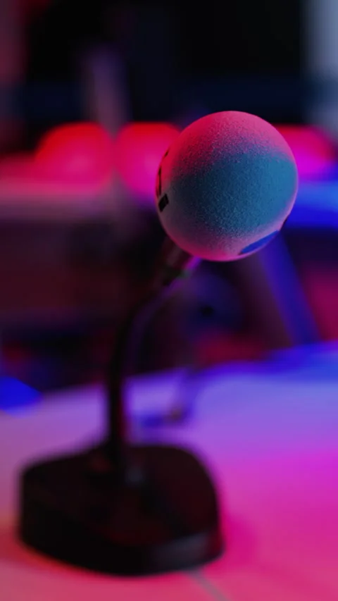 Close up of a microphone on a blurred background with blue and red lights at the Stock Footage 305854250