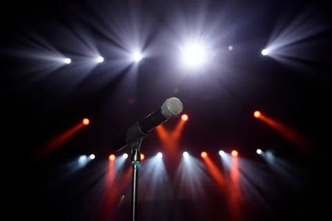 Close-up of microphone at concert against blur colorful light background Stock Photos