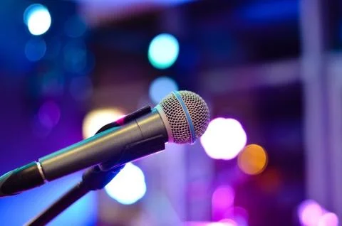 Close-up  of microphone on a defocused  background with multi colored lights Stock Photos