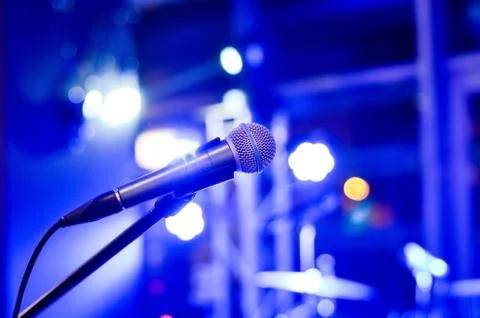 Close-up  of microphone on  empty  stage  with multi colored   blurred  backg Stock Photos