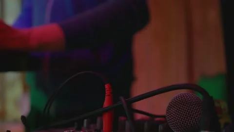 A close-up microphone lies on the sound control panel into which wires with Stock Footage 147405939
