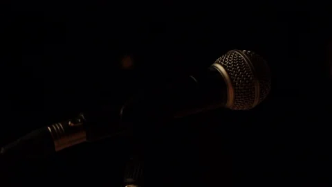 Close up of microphone on mic stand on a black background Stock Footage 107628533