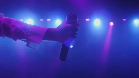 Close-up of the microphone in the singer's hand at an entertainment concert. Stock Footage 125604957