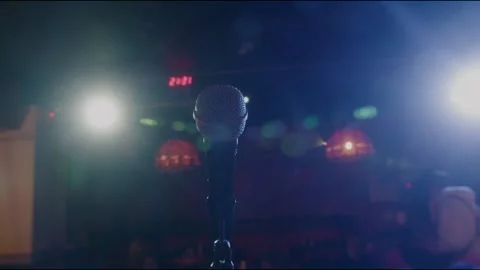 Close-up of microphone on stage against a black background with white lighting Stock Footage 150051937