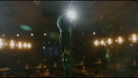 Close-up of microphone on stage against a black background with white lighting Stock-Footage 152182686