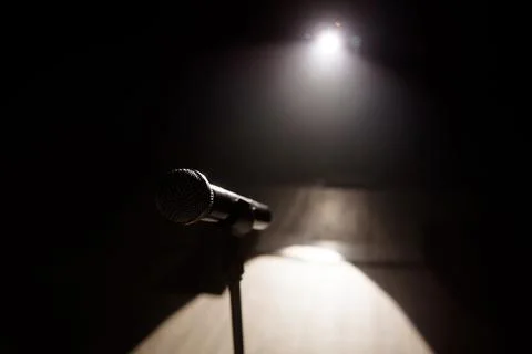 Close up of microphone on stage in black background Stock Photos