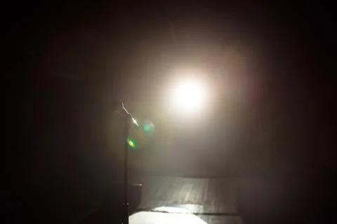 Close up of microphone on stage in black background Stock Photos