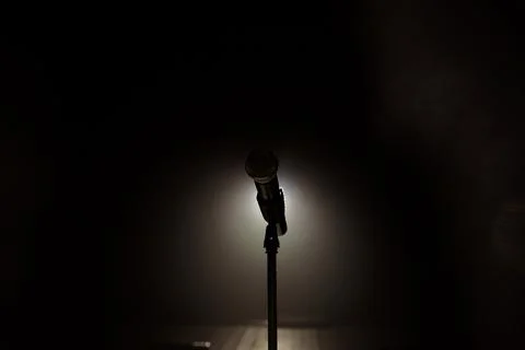 Close up of microphone on stage in black background Stock Photos