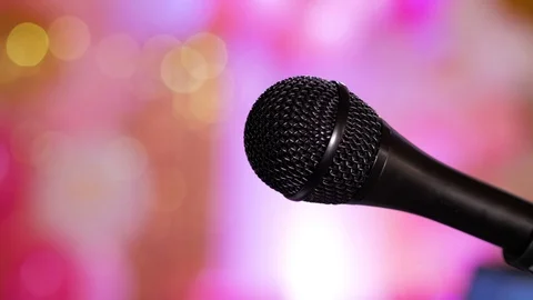 Close-up of microphone on stage on a pink glitter background. Stock Footage 105195157